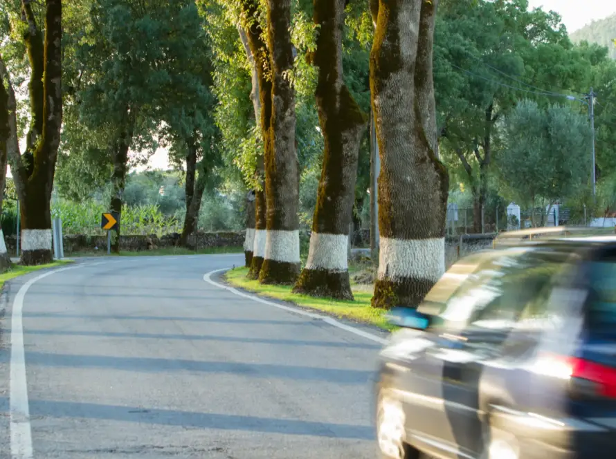 Blurry car speeding down bend in road