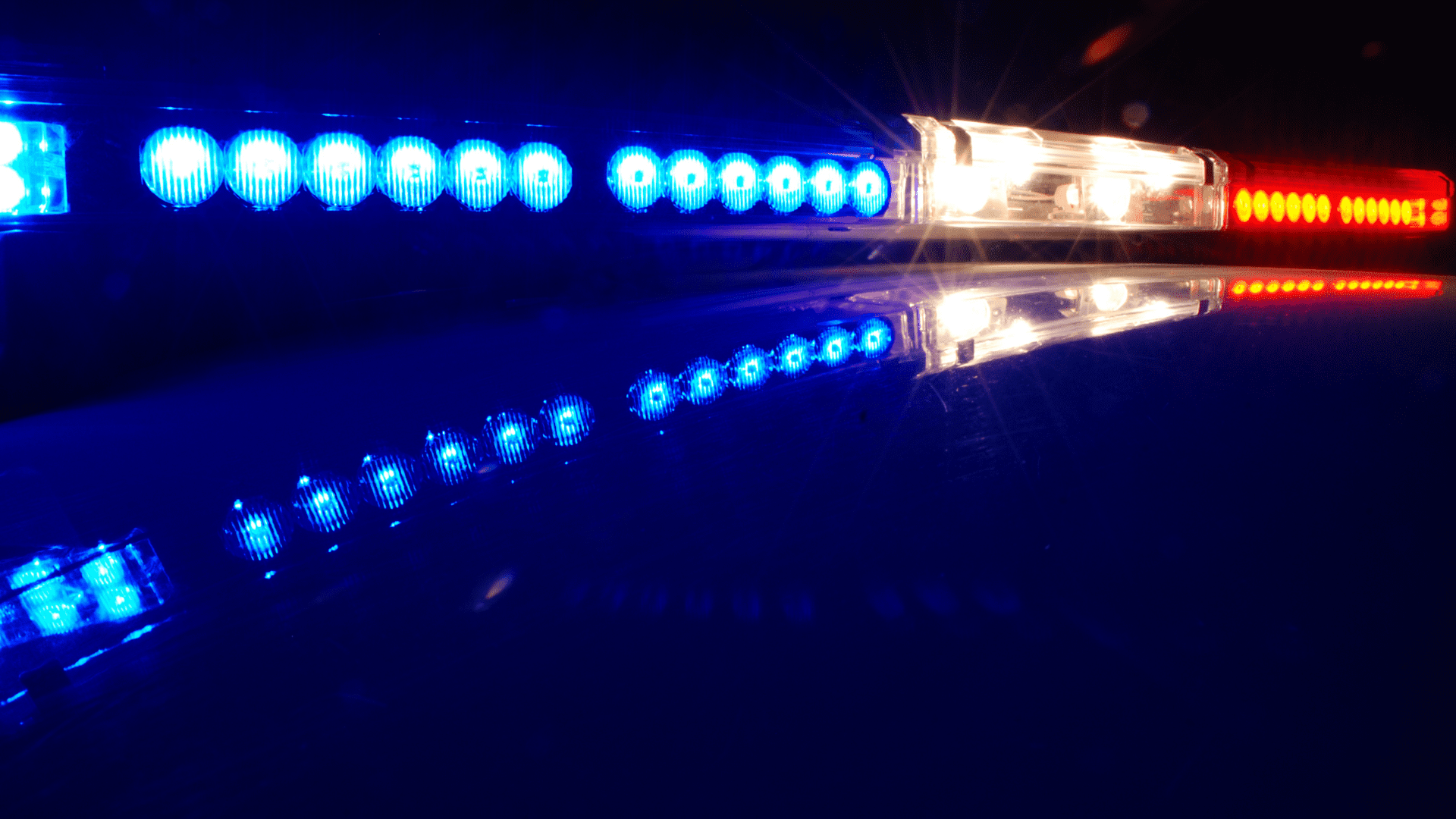 Zoomed in blue and red lights on top of a car